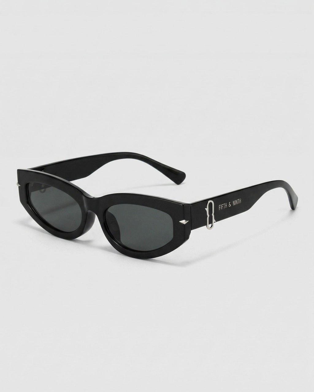 Black sunglasses with gold accents on a white background