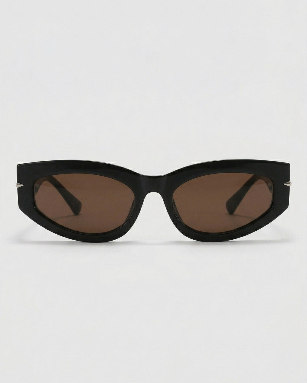 Black cat-eye sunglasses with brown lenses on a light gray background