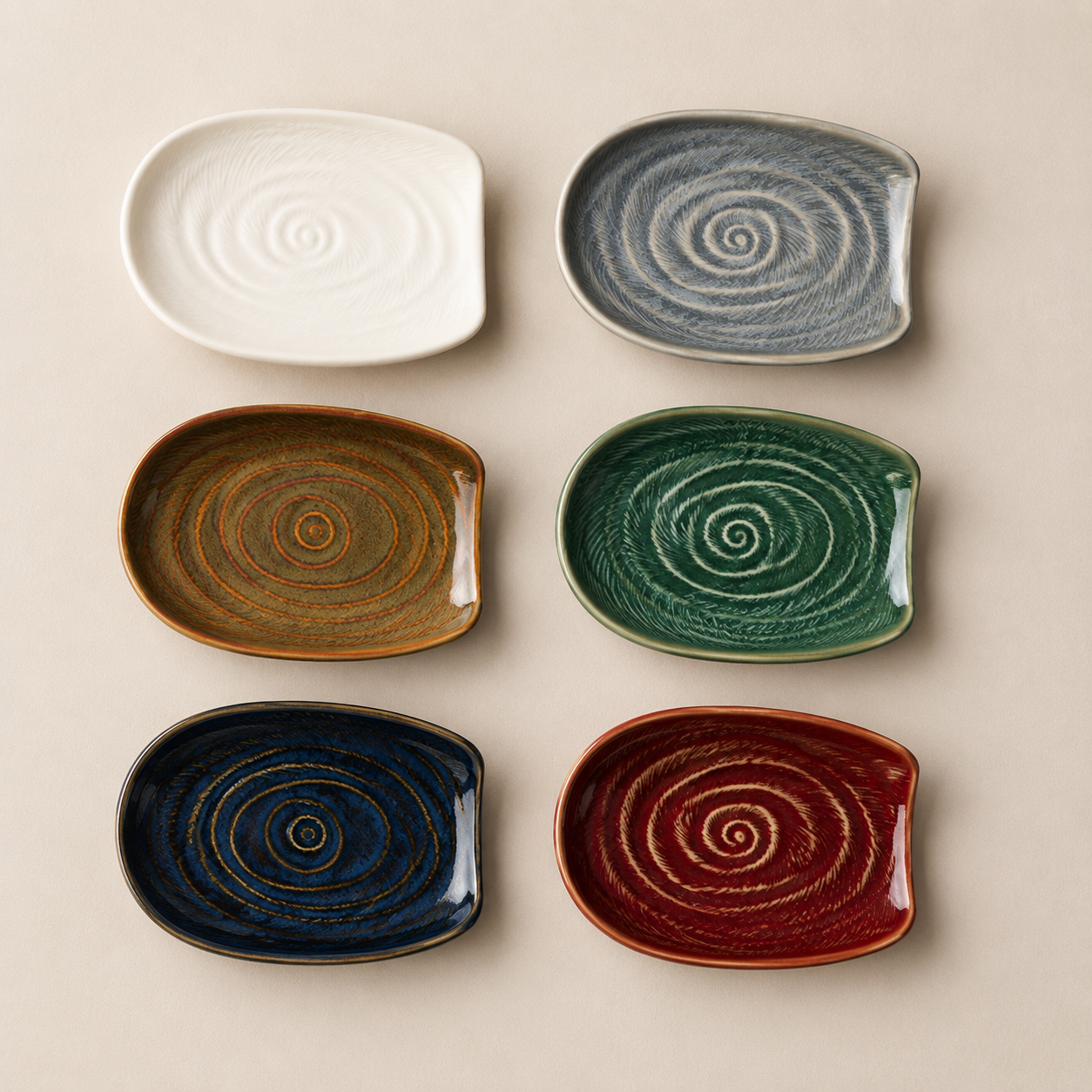 Six ceramic plates with a spiral pattern, shown in white, gray, brown, green, navy, and red, arranged in a grid on a beige background.