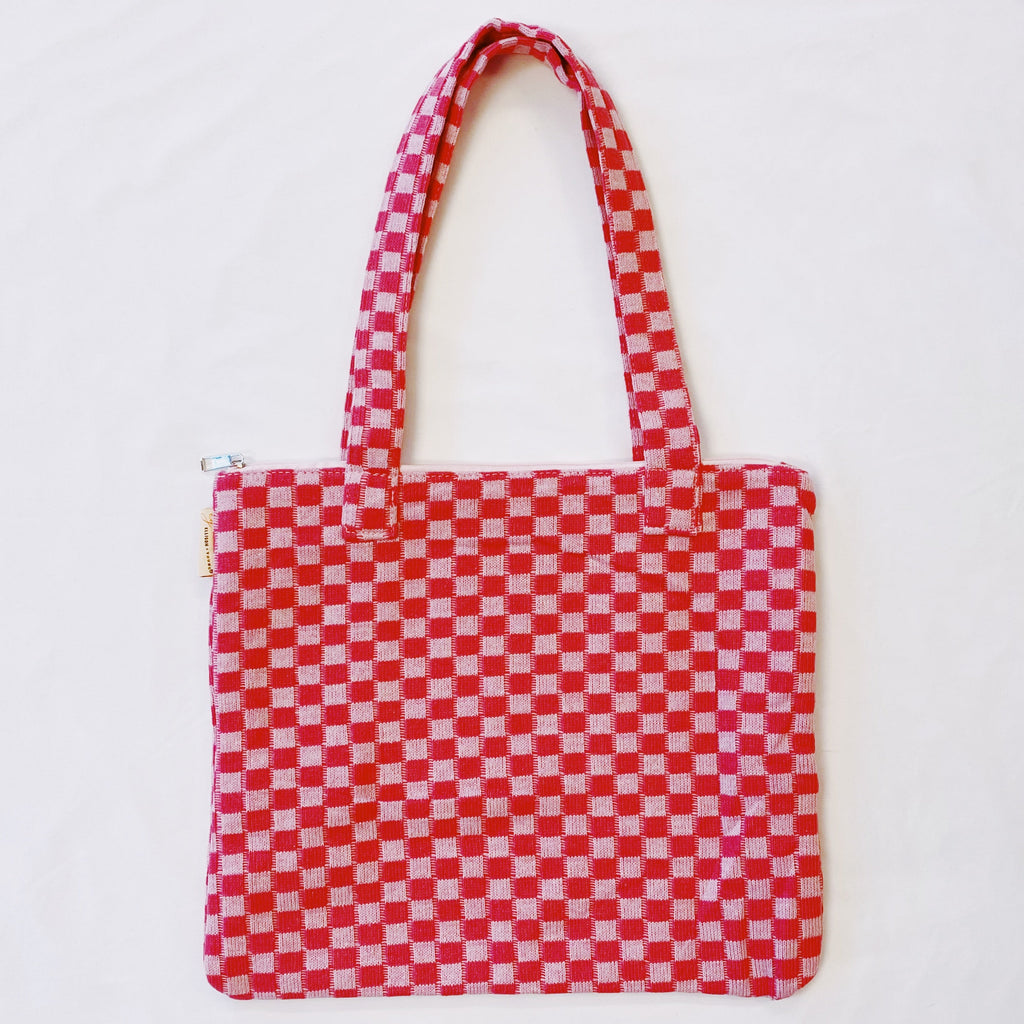 Red and white checkered tote bag on a light gray background