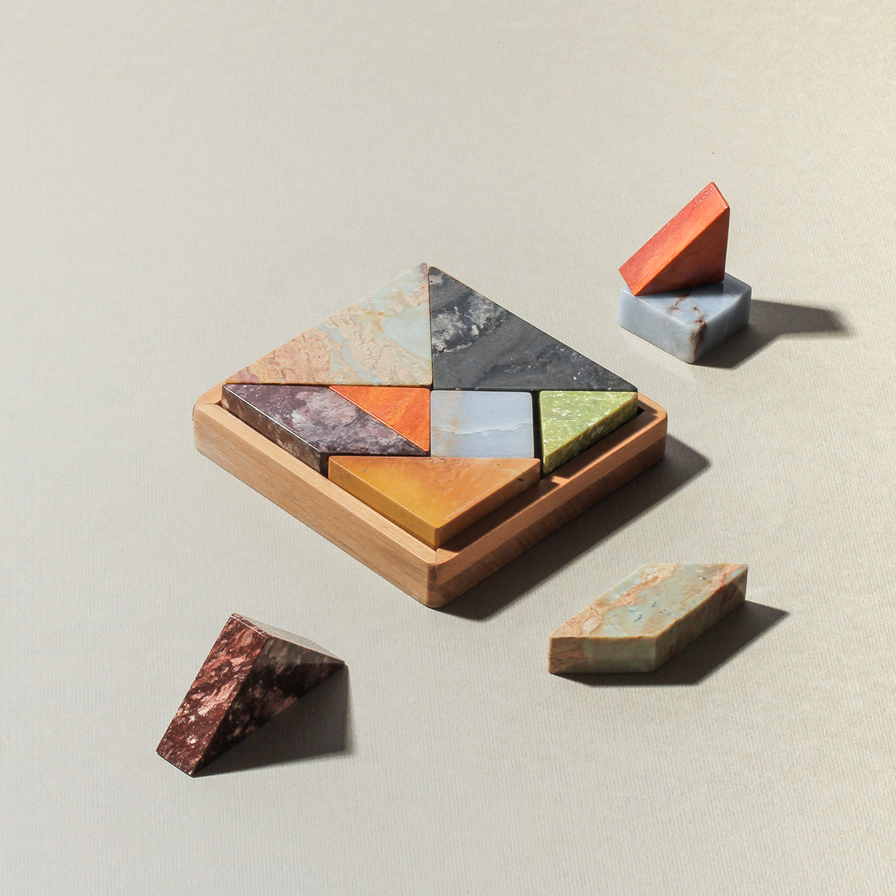 Set of geometric stone puzzle pieces on a neutral background