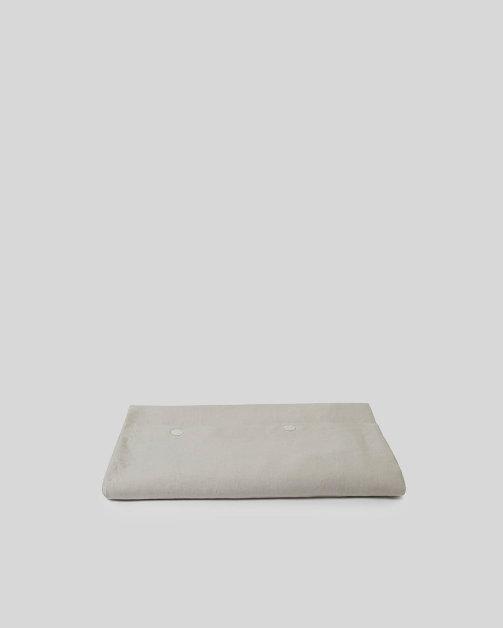 Beige rectangular cushion on a light gray background