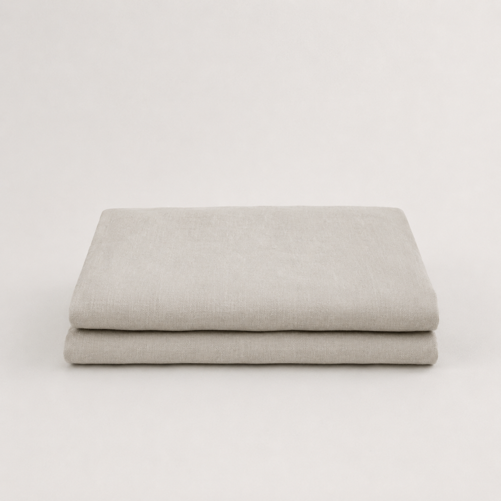 A folded light gray fabric item, likely a sheet or blanket, displayed on a clean white background.