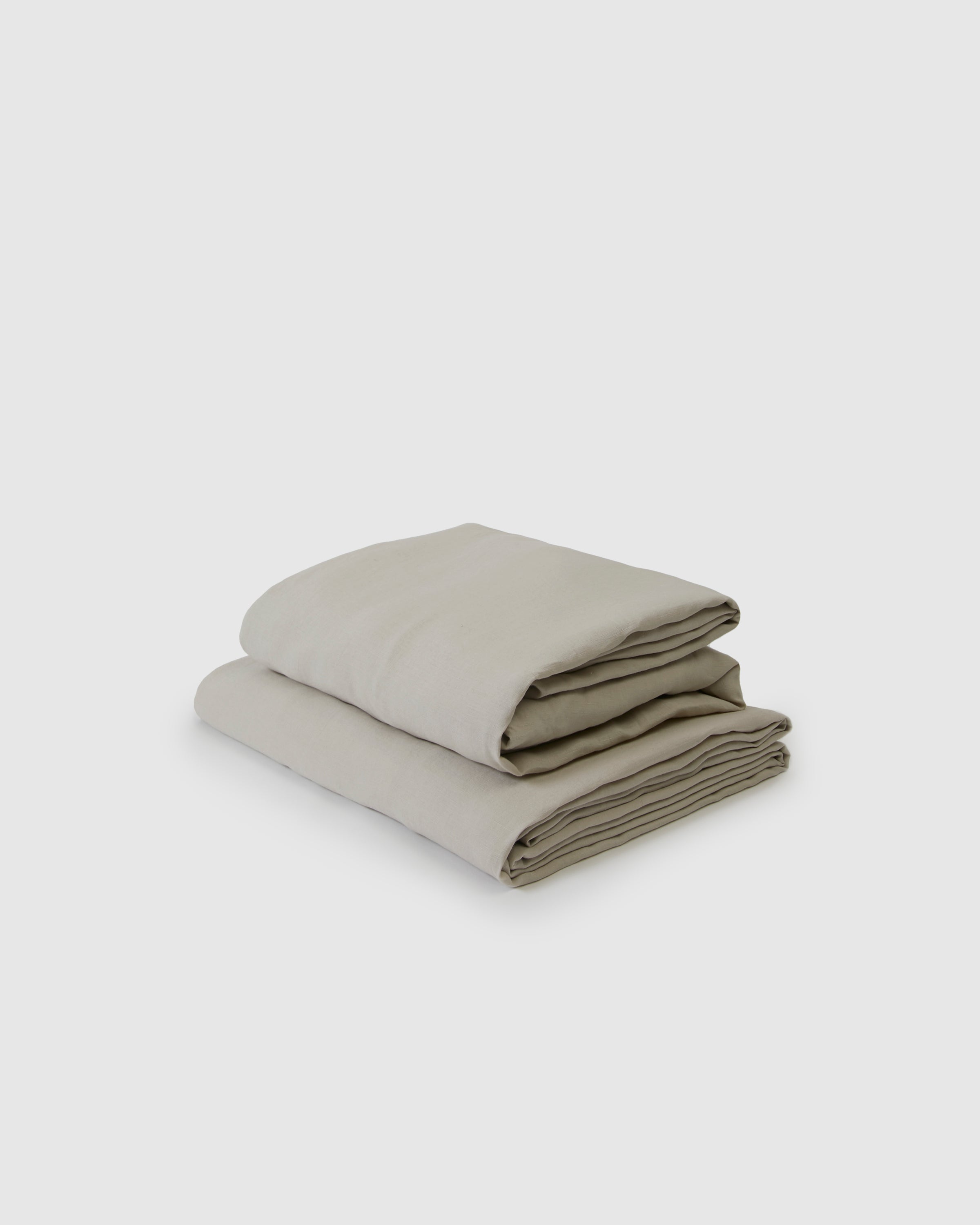 Folded beige fabric on a light gray background