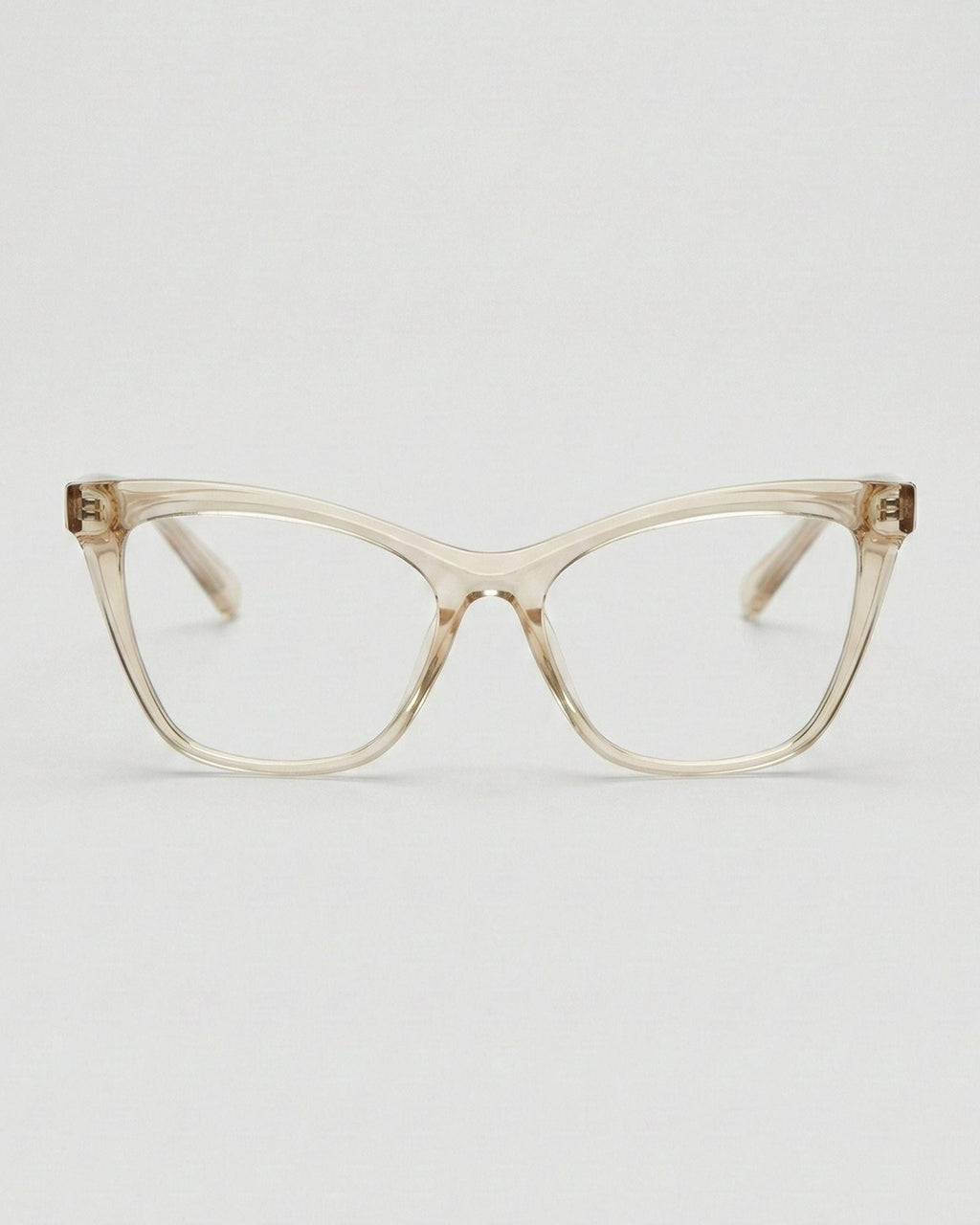 Cat-eye glasses with a transparent beige frame on a light gray background