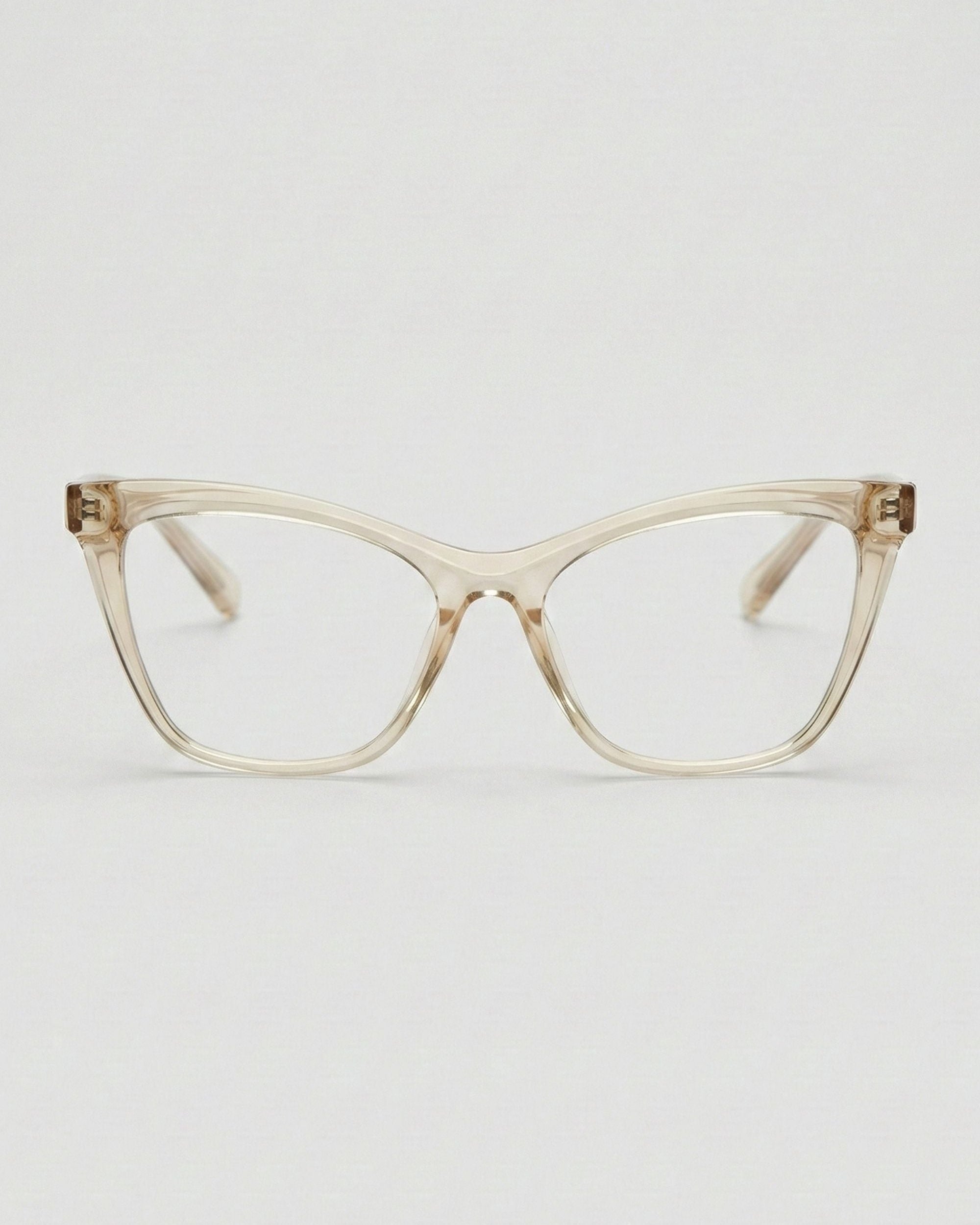 Cat-eye glasses with a transparent beige frame on a light gray background
