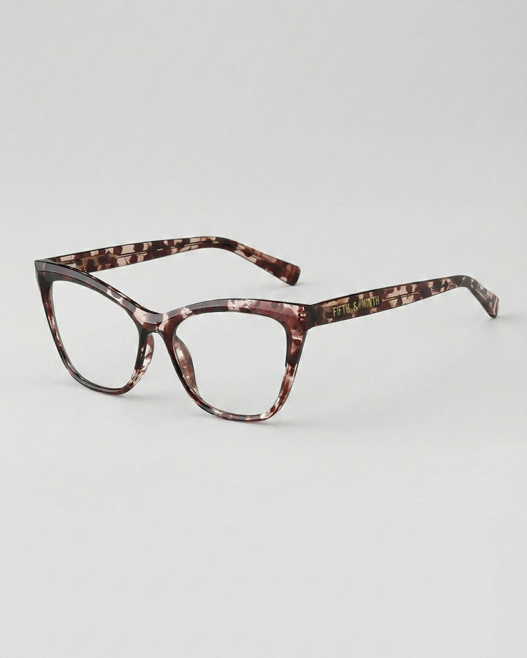 Tortoiseshell cat-eye glasses on a light gray background