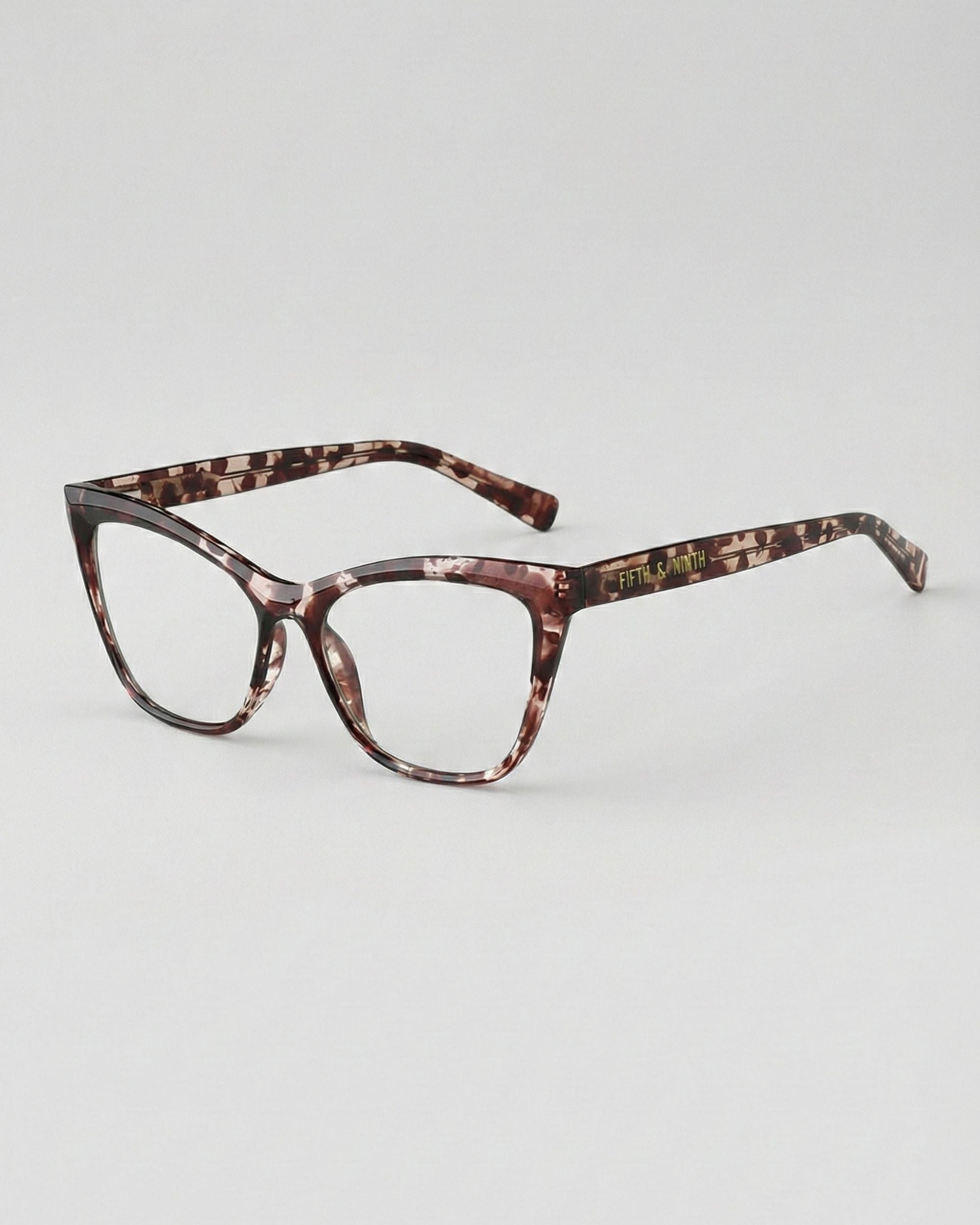 Tortoiseshell cat-eye glasses on a light gray background
