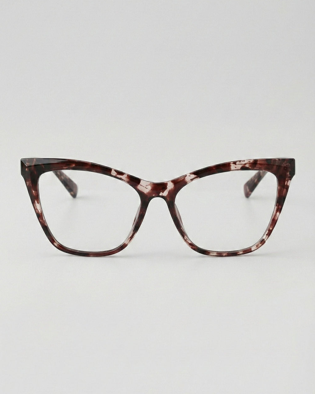Tortoiseshell cat-eye glasses on a light gray background