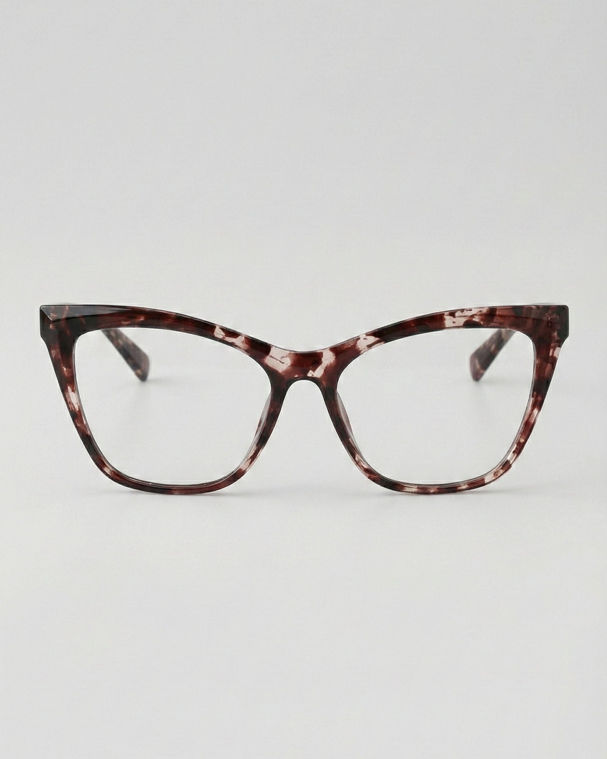 Tortoiseshell cat-eye glasses on a light gray background